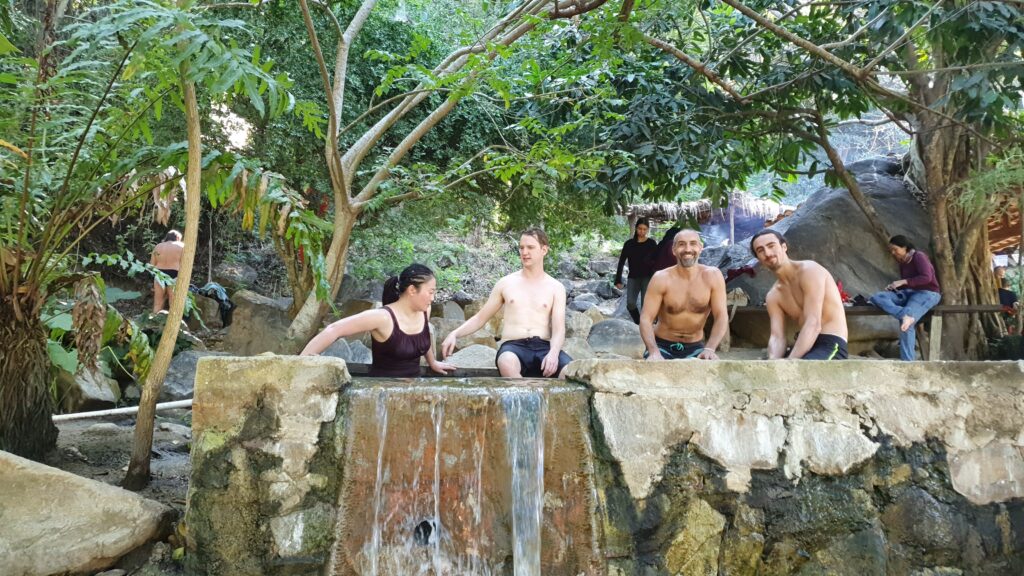 People enjoying a small waterfall in Puerto Escondido